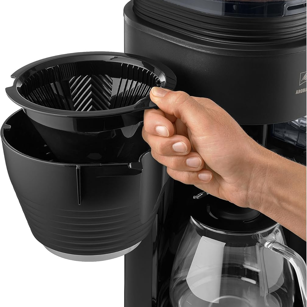 Melitta Aromafresh X Pro removable filter basket being lifted out by hand
