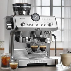De'Longhi EC9555.M brewing two espresso shots on a kitchen counter with iced coffee alongside