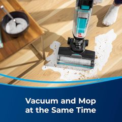 BISSELL CrossWave HF2 3845E vacuuming and mopping a spill at the same time on a hardwood floor