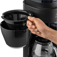 Melitta Aromafresh X Pro removable filter basket being lifted out by hand