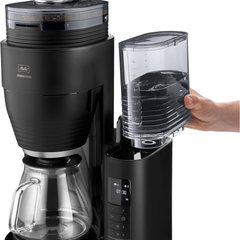 Melitta Aromafresh X Pro removable water tank being filled by hand